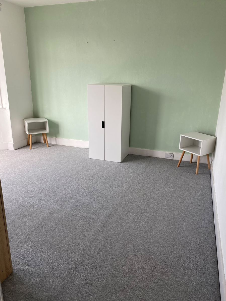 The same bedroom after cleaning, carpet uniform and clear