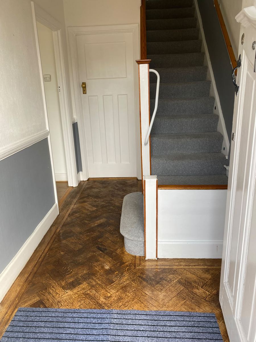 The same hallway after cleaning, parquet clear and the stair carpet vacuumed