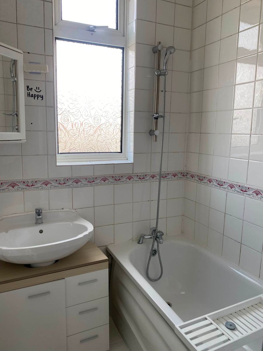 Clean family bathroom with bath, shower and basin